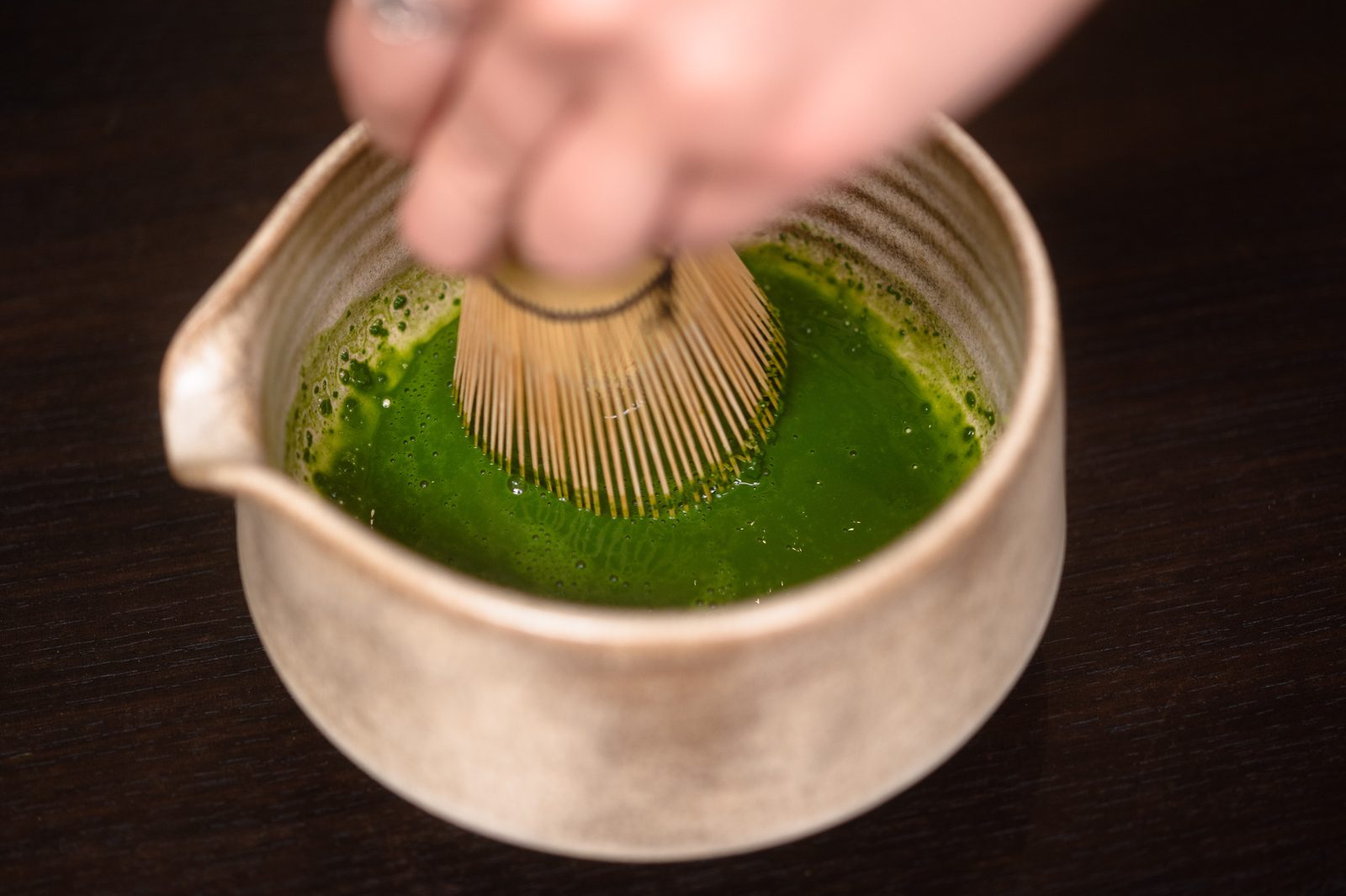 Whisking matcha with a bamboo chasen